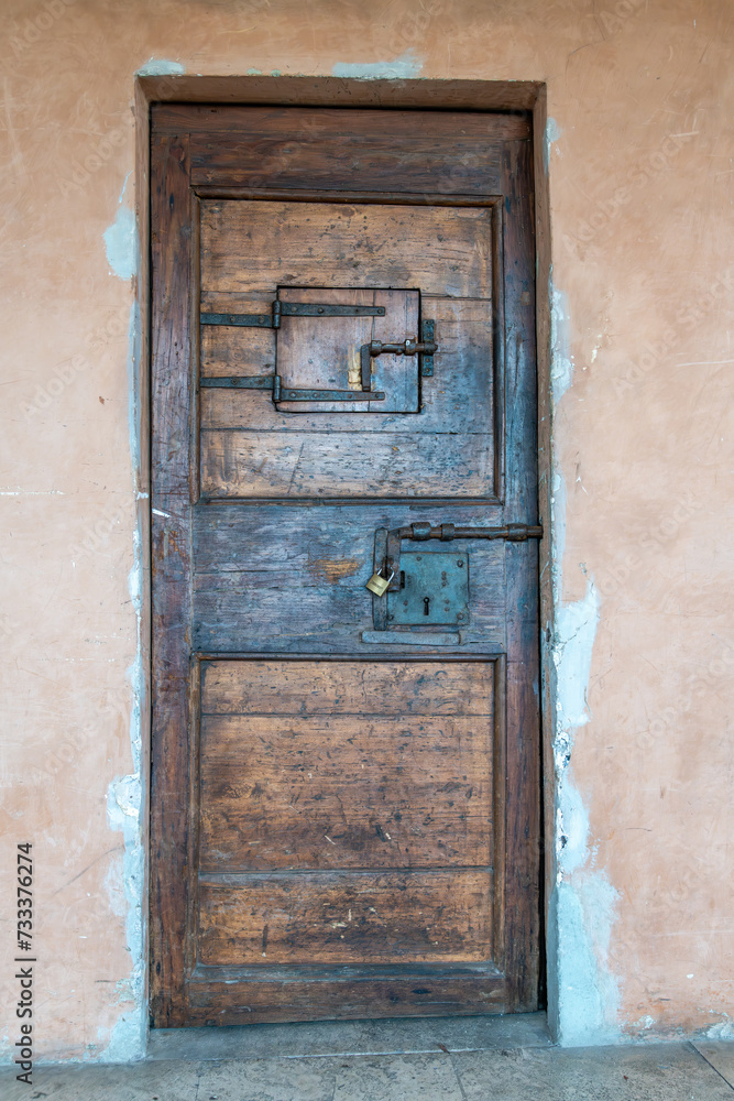 Ancient Wooden Door with Iron Lock in Historic Building