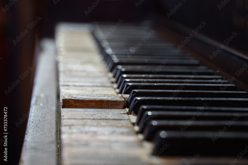 An old very worn antique piano with dirty and damaged keys must have many stories to tell. A keyboard with stained and worn white keys that may not work anymore is still amazing. Upstate NY. An old very worn antique piano with dirty and damaged keys must have many stories to tell. A keyboard with stained and worn white keys that may not work anymore is still amazing. Upstate NY.