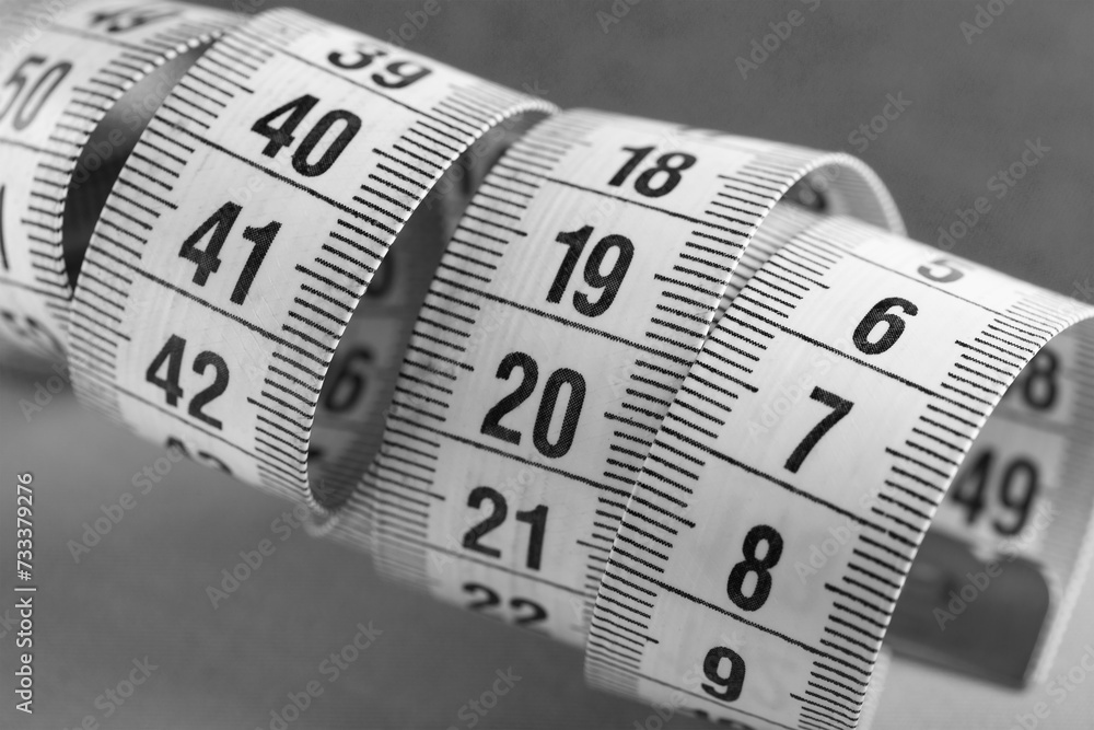sewing tape measure for taking measurements on a black and white background sewing tape measure for taking measurements on a black and white background