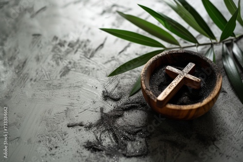 Ash Wednesday,faith, liturgy, religious ceremony background. Wooden cross, ceremonial dish with ash and palm leaf branch on gray background. Top view