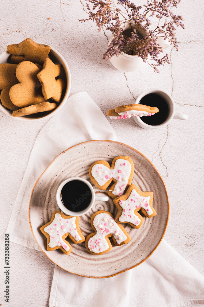 Sweet Mug-Hugging Cookies and cup of coffee on a plate top and vertical view