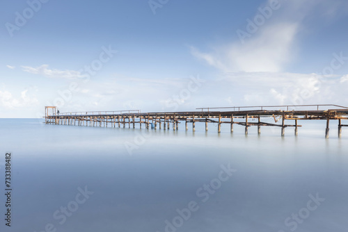 Awesome calming long exposure landscape of ruined pier rusted. long exposure seascape 