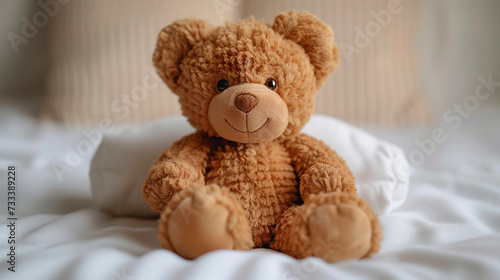 Teddy bear on white bed 