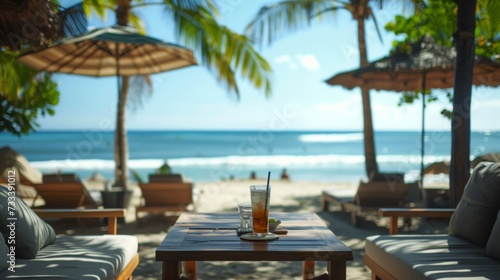 A chic beachfront lounge, with tropical cocktails served against a backdrop o...