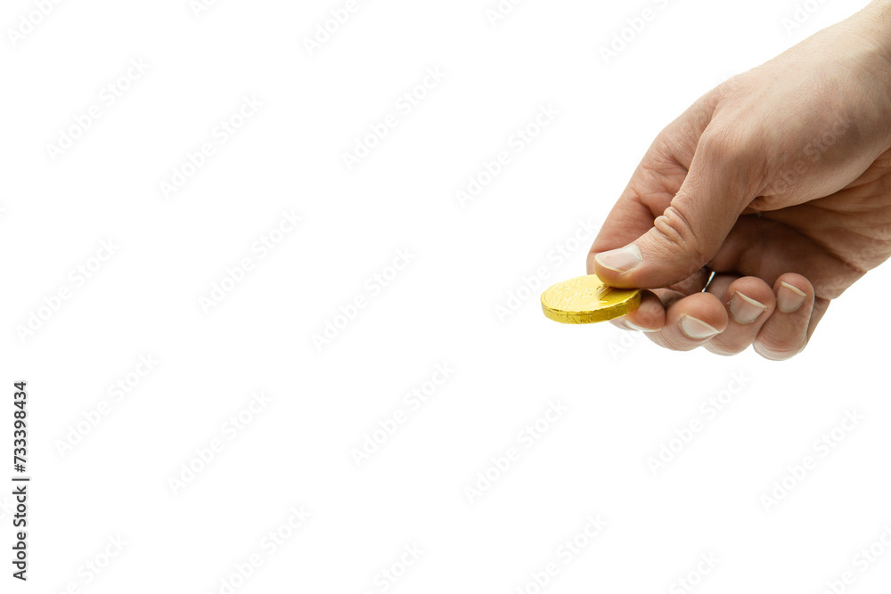 Fototapeta premium Male hand holding chocolate coin, stack of coins in the background isolated on white background, copy space