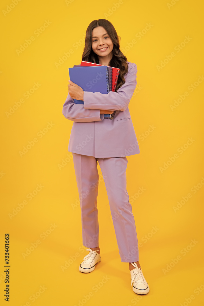Schoolgirl with copy book posing on isolated background. Literature lesson, grammar school. Intellectual child reader. Schoolgirl with copy book posing on isolated background. Literature lesson, grammar school. Intellectual child reader.