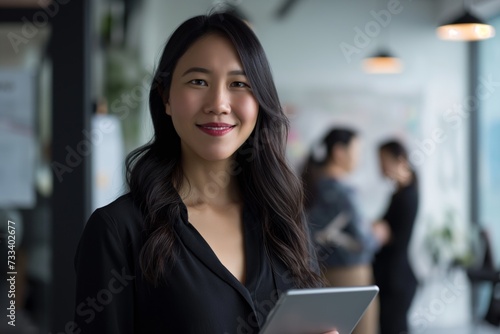 Smiling confident business leader looking at camera and standing in an office
