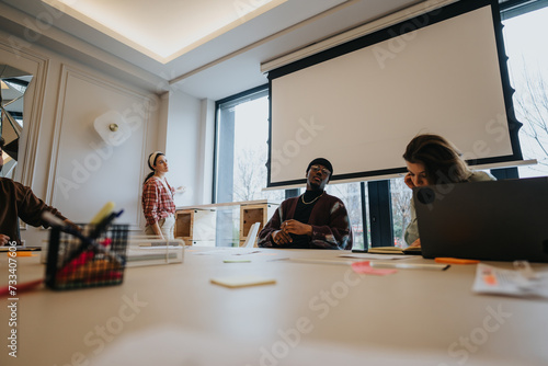 Mixed race, business coworkers in a business meeting with discussion in modern office space.