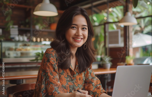 A beautiful Indonesian girl working remotely photo