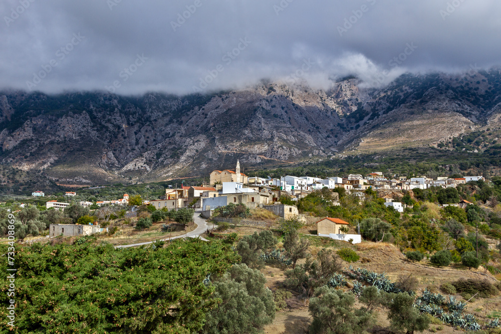 Psiloritis mountain with low cloud coverage and the traditional village of Fourfouras, in central Crete island, very close to Rethymno town, in Greece