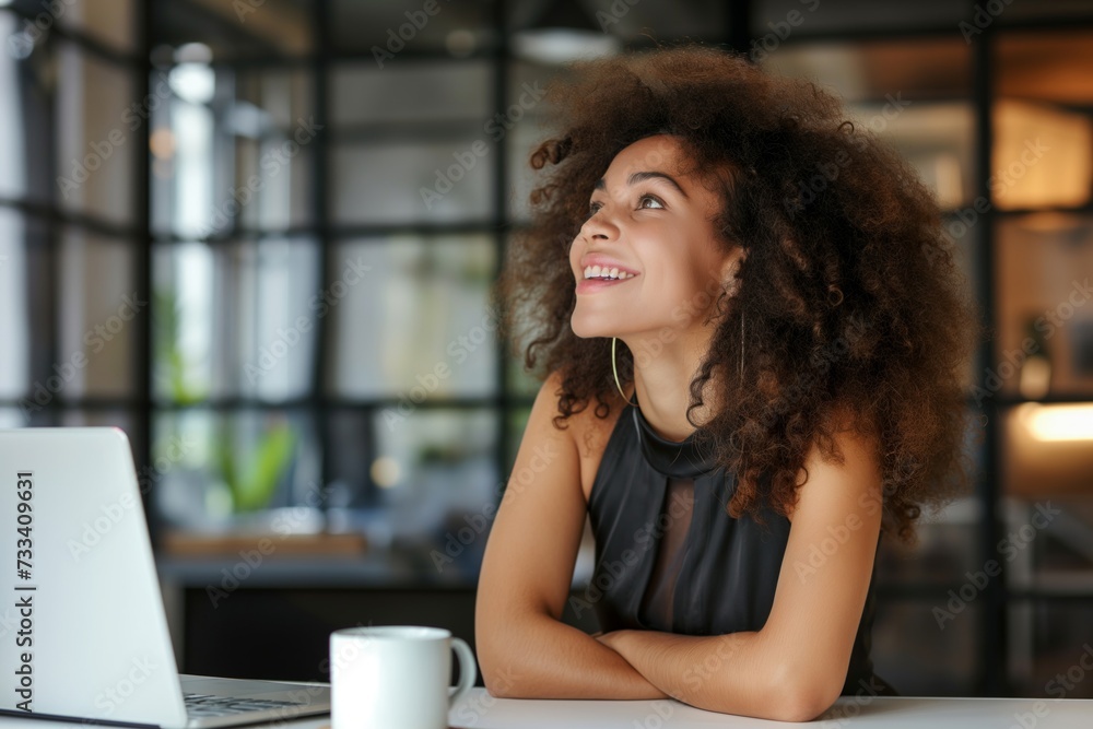 Happy African American woman in casual clothes working in office with laptop Happy African American woman in casual clothes working in office with laptop