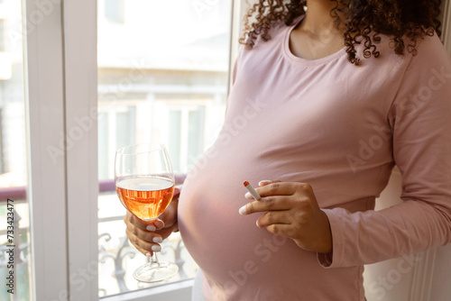 Closeup of irresponsible pregnant woman with cigarette and wine glass
