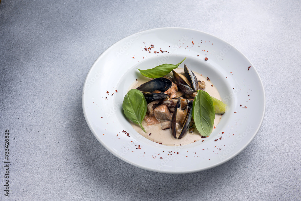 a dish of mussels and basil on a plate. Close up a dish of mussels and basil on a plate. Close up