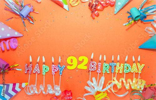 Top view birthday background with number  92. A beautiful holiday postcard on a colorful background with decorations. Anniversary congratulations with a number. Words from candles birthday. photo