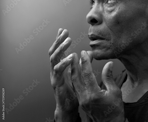 black man praying to god with black grey background with people stock image stock photo