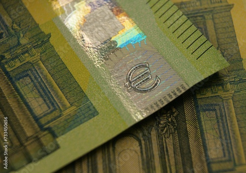 A fragment of a 100 euro banknote with a hologram.