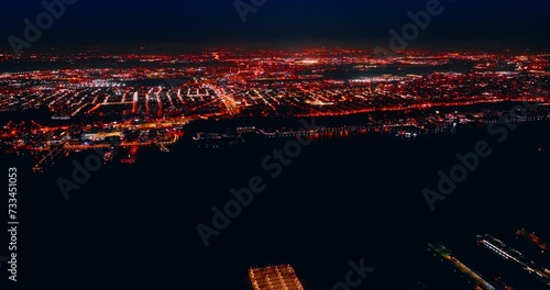 Luminous panorama of New York with billions of lights at night. Footage from above the dark area of water from top. photo