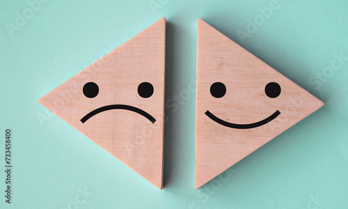 Obraz na plátně Pessimism and optimism - on wooden triangles on a gray-blue background