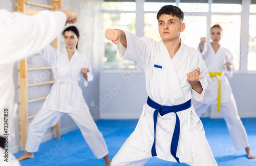 Fighting stance of men and women during group karate training