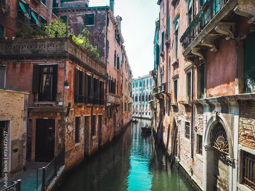 Narrow canal in Venice with beautiful old buildings on each side