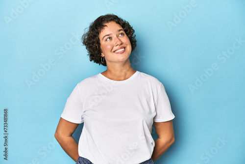 Young Caucasian woman with short hair relaxed and happy laughing, neck stretched showing teeth.