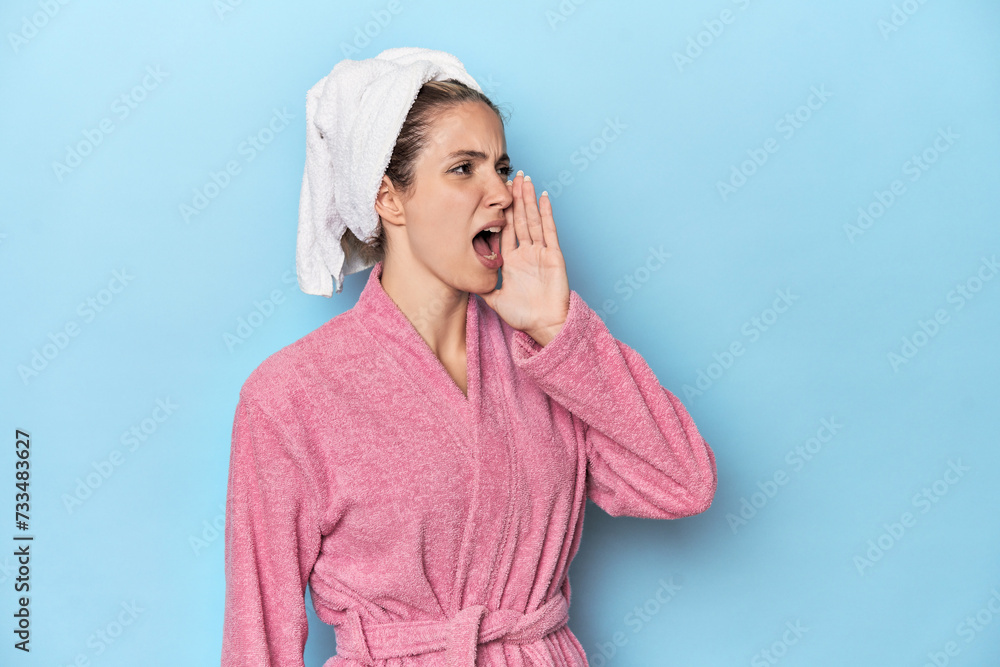 Woman in pink robe after shower shouting and holding palm near opened mouth. Woman in pink robe after shower shouting and holding palm near opened mouth.