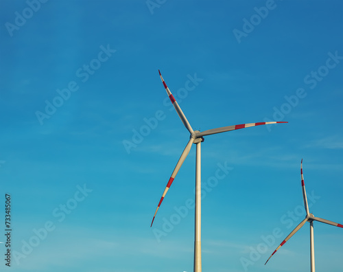 Wind farm park next to a road in Austria in sunny weather. © Nataliia