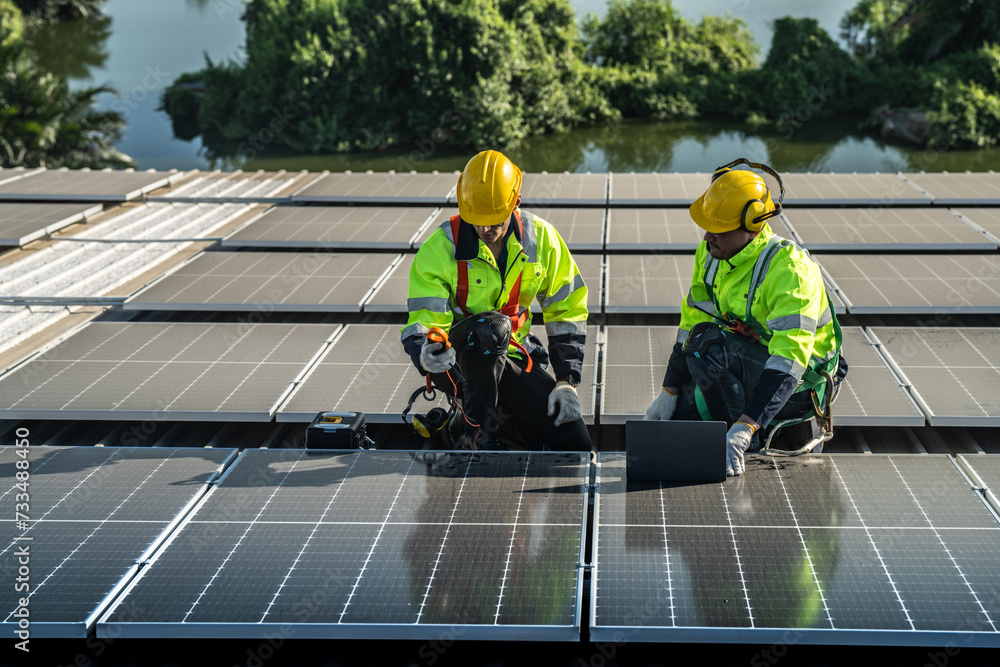 Worker Technicians are working to construct solar panels system on roof. Installing solar photovoltaic panel system. Alternative energy ecological concept. Renewable clean energy technology concept. Worker Technicians are working to construct solar panels system on roof. Installing solar photovoltaic panel system. Alternative energy ecological concept. Renewable clean energy technology concept.