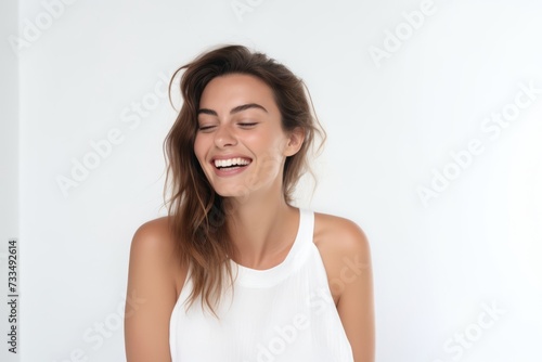 Portrait of a beautiful young woman laughing, isolated on white background