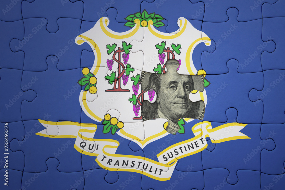 Naklejka premium puzzle with the national flag of connecticut state and usa dollar banknote. finance concept