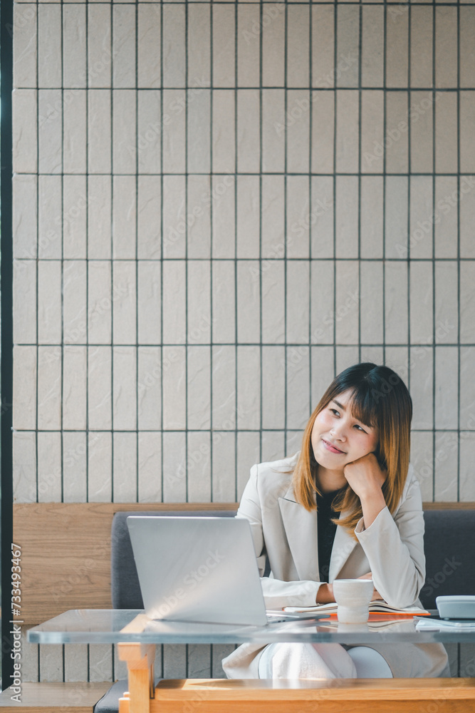 Freelancer concept, Cheerful young businesswoman enjoying a break with a laptop at a cafe, showcasing a relaxed work environment. Freelancer concept, Cheerful young businesswoman enjoying a break with a laptop at a cafe, showcasing a relaxed work environment.