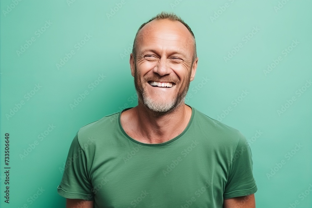 Portrait of a smiling middle-aged man on a green background Portrait of a smiling middle-aged man on a green background