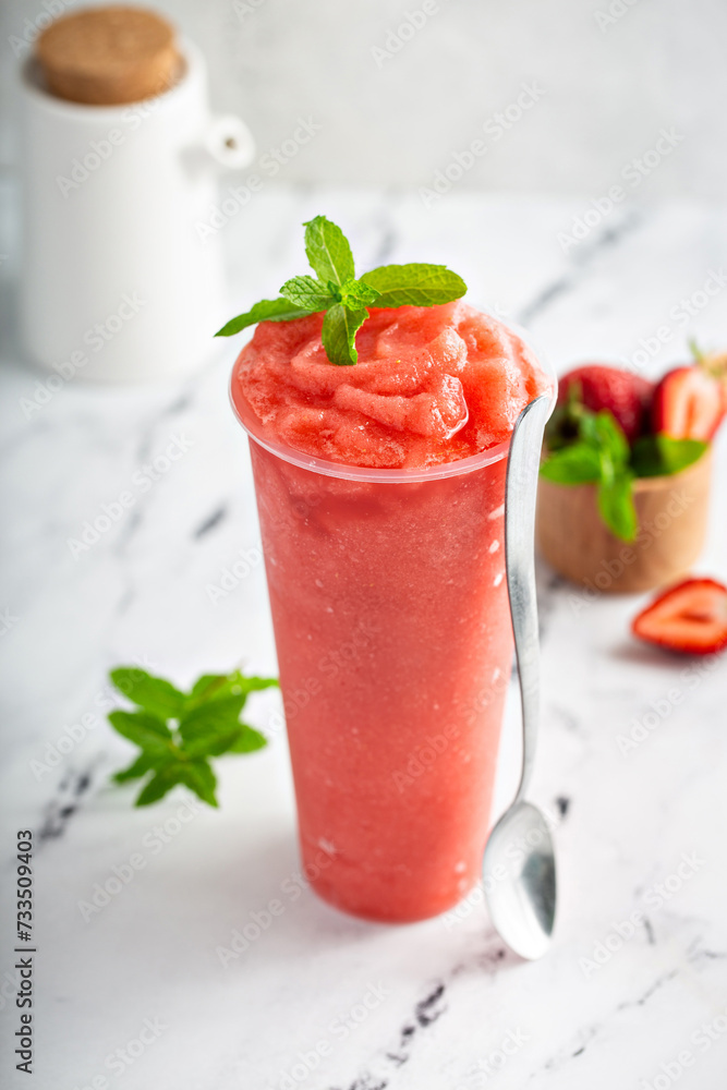 Strawberry watermelon smoothie or slushie in a tall cup Strawberry watermelon smoothie or slushie in a tall cup