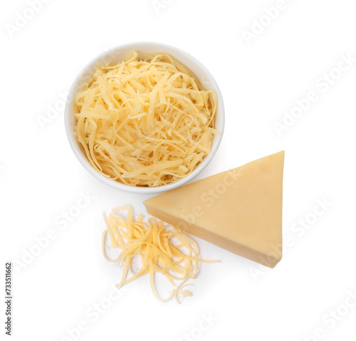 Grated and whole piece of cheese isolated on white, above view