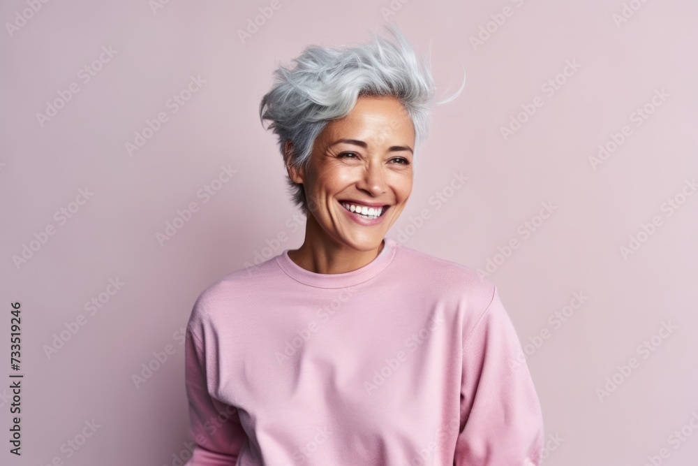 Portrait of a happy senior woman with short grey hair on a pink background Portrait of a happy senior woman with short grey hair on a pink background