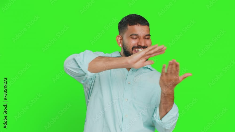 Indian man showing wasting throwing sharing money around, more tips, big profit, winning lottery jackpot, successful shopping payment purchase cashback. Arabian guy isolated on chroma key background Indian man showing wasting throwing sharing money around, more tips, big profit, winning lottery jackpot, successful shopping payment purchase cashback. Arabian guy isolated on chroma key background