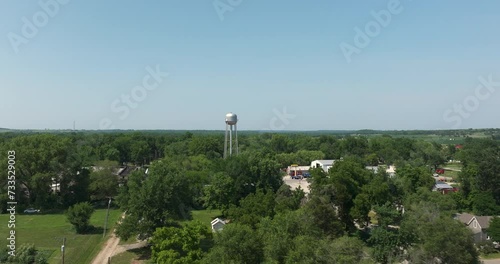 Flying over small midwest kansas town with water tower photo