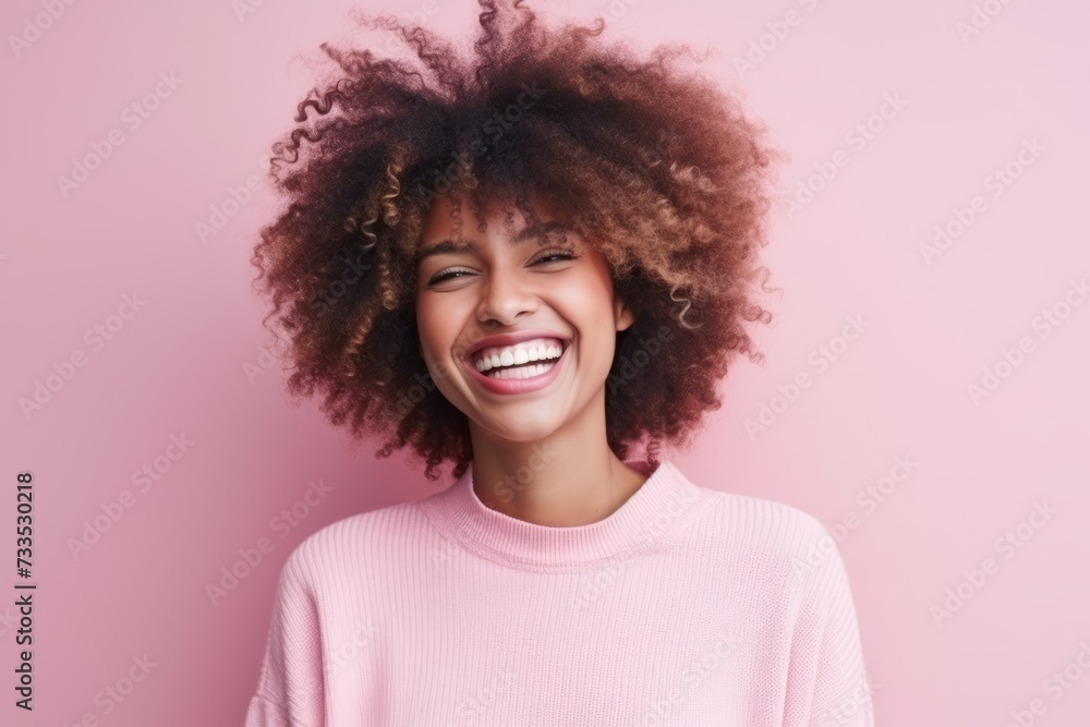 Portrait of a beautiful young african american woman laughing over pink background Portrait of a beautiful young african american woman laughing over pink background