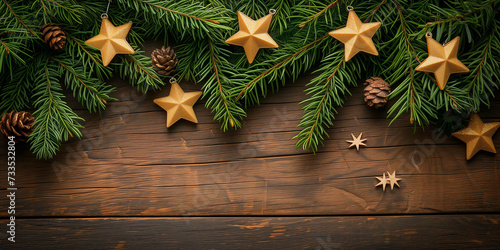 Fir tree branches and advent calendar stars on old wooden board.