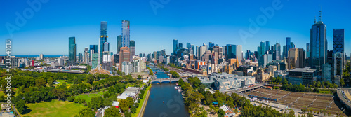 An aerial view of the Melbourne CBD Skyline behind the Yarra River on a sunny morning in summer. 
