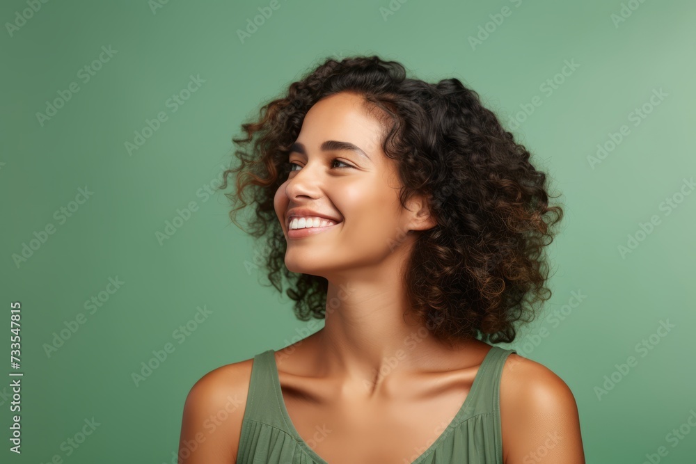 happy african american young woman with curly hair on green background happy african american young woman with curly hair on green background