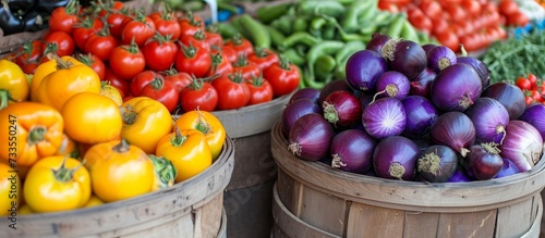 There is a variety of vegetables in the baskets, showcasing diverse food ingredients from the local market.