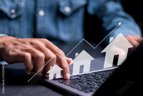 Real estate investment concept. Person using laptop with house icon and growth graph. Analyzing mortgage loan home and insurance real property mortgage. interest rate, Investment planning.