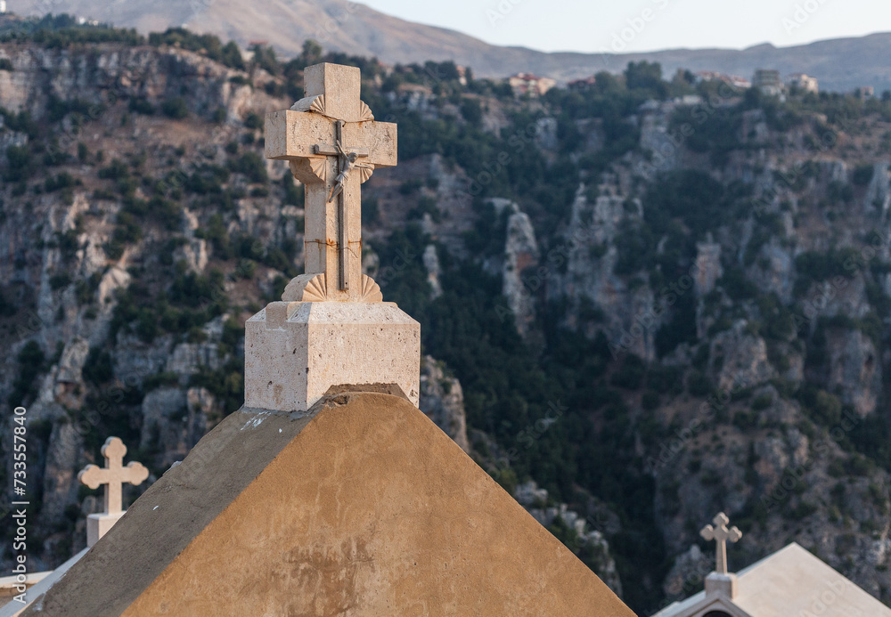 A crucifix stands over a tomb in the Lebanon mountains.