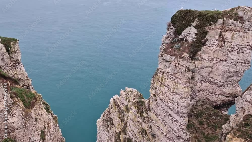 Natural view to famous Falaise d'Aval coastline cliffs and the blue ocean water on the horizon Natural view to famous Falaise d'Aval coastline cliffs and the blue ocean water on the horizon