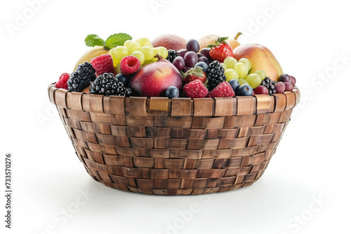A wooden woven basket with fruits and berries, isolated on white