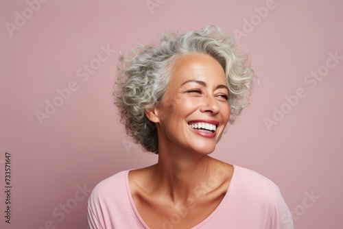 Portrait of a happy senior woman with grey hair and white smile
