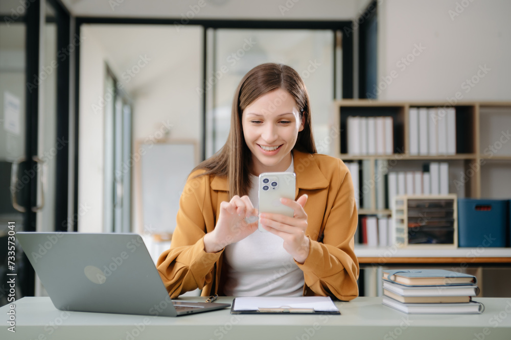 Confident woman with a smile standing holding notepad and tablet at the office. Confident woman with a smile standing holding notepad and tablet at the office.