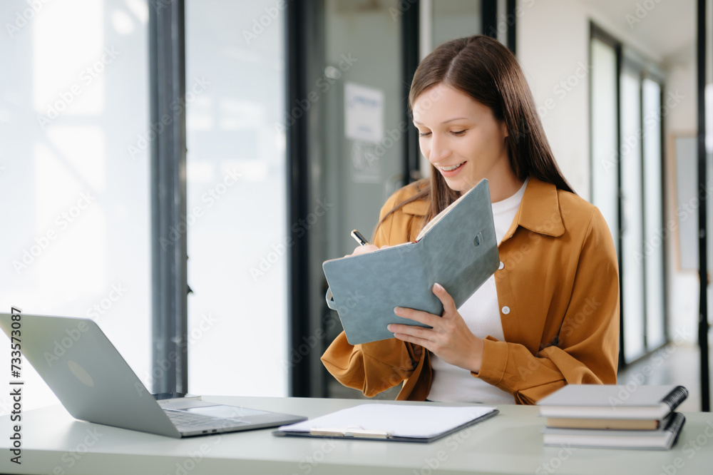 Businesswoman working in the office with working notepad, tablet and laptop documents . Businesswoman working in the office with working notepad, tablet and laptop documents .