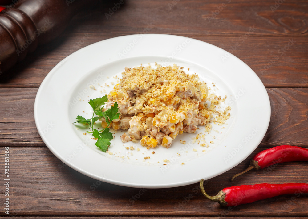Chicken and corn salad. On a wooden background. Chicken and corn salad. On a wooden background.